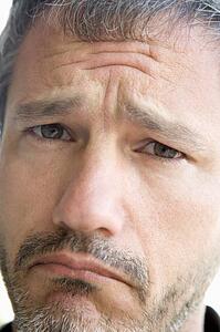 Head shot of sad man