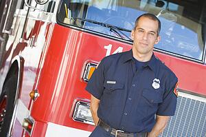 Fireman standing in front of fire engine