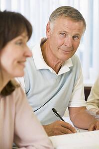 Adult students studying at table (selective focus)