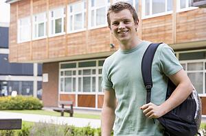 Student standing outdoors smiling