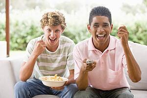 Teenage Boys Sitting On Couch Together 