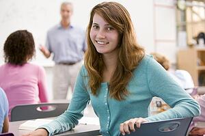 Female student with other students in classroom