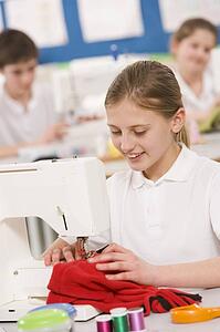 Female student using sewing machine