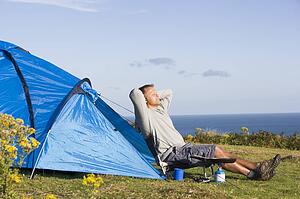 Man camping outdoors and cooking