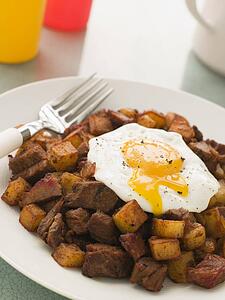 Corned Beef Hash with a Broken Fried Egg and Black Pepper