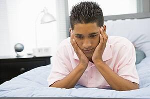 Teenage Boy Lying On Bed