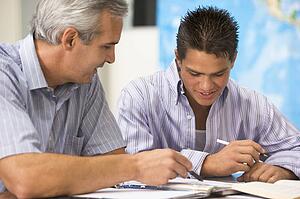 Teacher giving personal instruction to male student