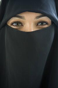 Woman wearing black veil indoors