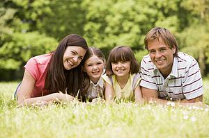 Family outdoors smiling