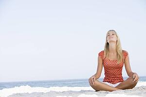 Young woman sitting on a beach