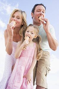 Family standing outdoors with ice cream