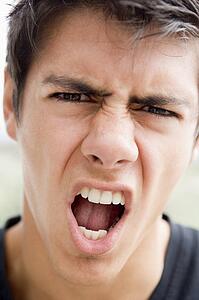 Head shot of man scowling
