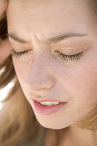 Head shot of woman scowling