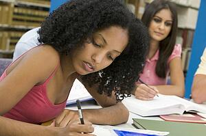 Four people in library studying