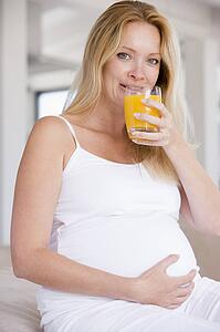 Pregnant woman with glass of orange juice