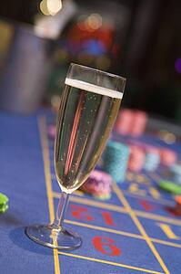 Champagne flute sitting on roulette table (selective focus)