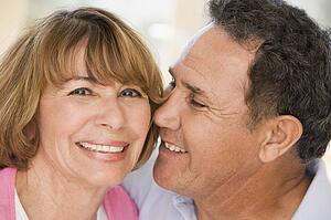 Couple relaxing in living room and smiling