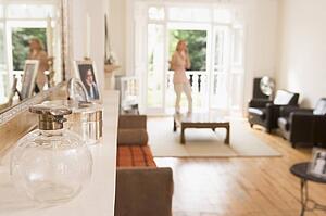Woman in living room talking on telephone