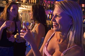 Young woman in a bar with friends