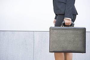 Businesswoman holding briefcase outdoors