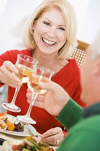 Couple Toasting At Christmas Dinner
