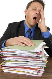 Businessman Overwhelmed By Paperwork