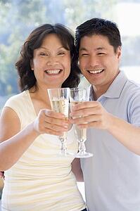 Couple toasting champagne and smiling