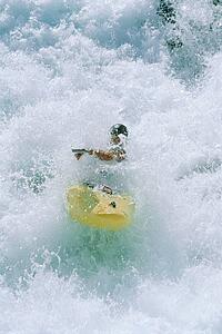 Kayaker rowing in rapids