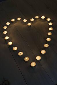 Illuminated Candles Placed In A Heart Shape