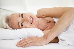 Woman lying in bed smiling