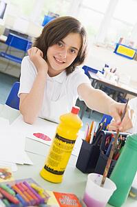 Student in art class with paints