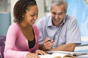 Teacher giving personal instruction to female student