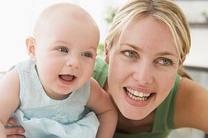 Mother in living room with baby smiling