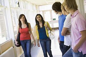 Students in corridor watching other students walking by (selective focus)