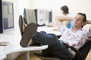 Man in computer room with feet up relaxing