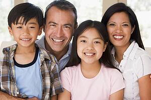 Family in living room smiling