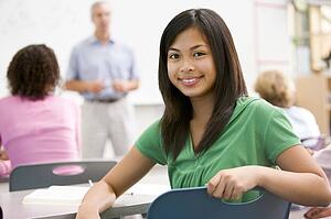 Female student with other students in classroom