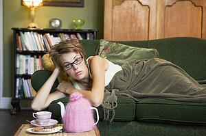 Young woman lying on sofa at home