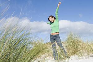 Young woman posing on a sand hill
