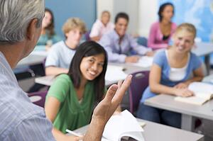 Students studying in geography class with teacher
