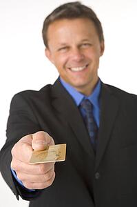 Businessman Handing Over Gold Credit Card 
