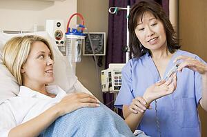 Doctor Taking Pregnant Woman’s Pulse