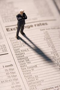 Figurine Of A Businessman With Arms Crossed Standing On A Financial Newspaper