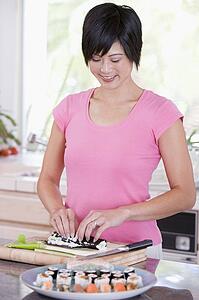 Women Preparing Sushi Rolls