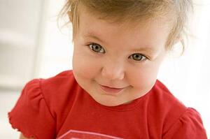 Baby indoors smiling