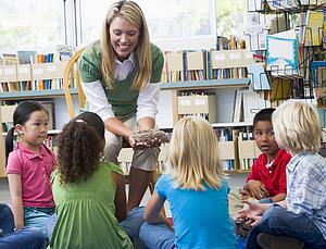 Teacher in class showing students a nest