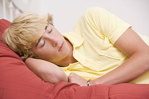 Teenage Boy Lying On Bed