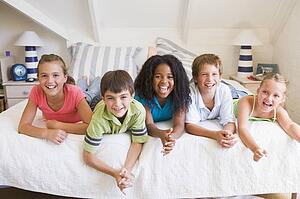 Five Young Friends Lying Down Next To Each Other