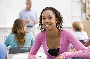 Female student with other students in classroom