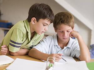 Two Young Boys Doing Their Homework Together